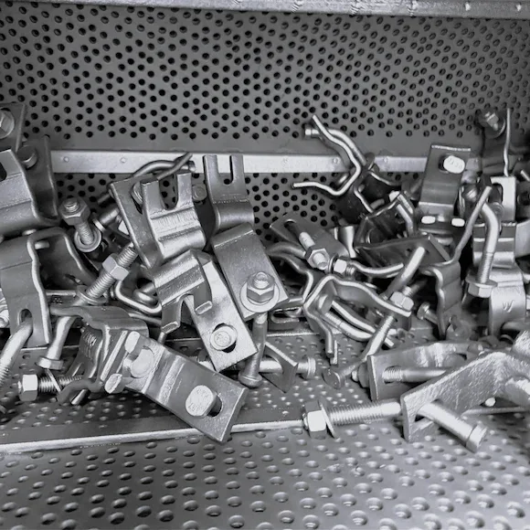 Shot blasting of scaffolding clamps