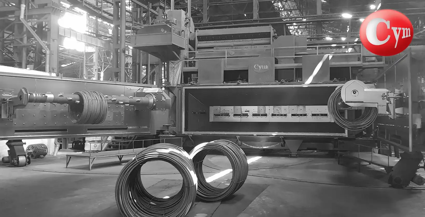 CYM COIL 5 blast machine – 5 m mandrel, 8 blast wheels 340 HP, coils on floor · Mukand Ltd, India