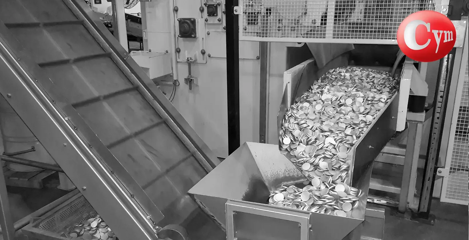 Automatic discharge of aluminium slugs from CYM LT 450 tumble belt blaster – 2 blast wheels 20 HP, bright surface finish ready for impact extrusion
