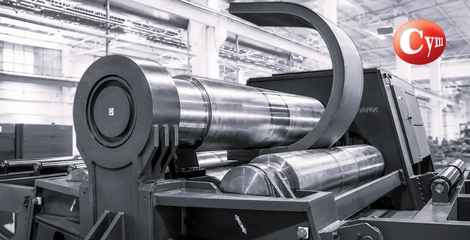 Close-up of the forming rolls on a four-roll CNC plate rolling machine with plate in process, CYM Materiales