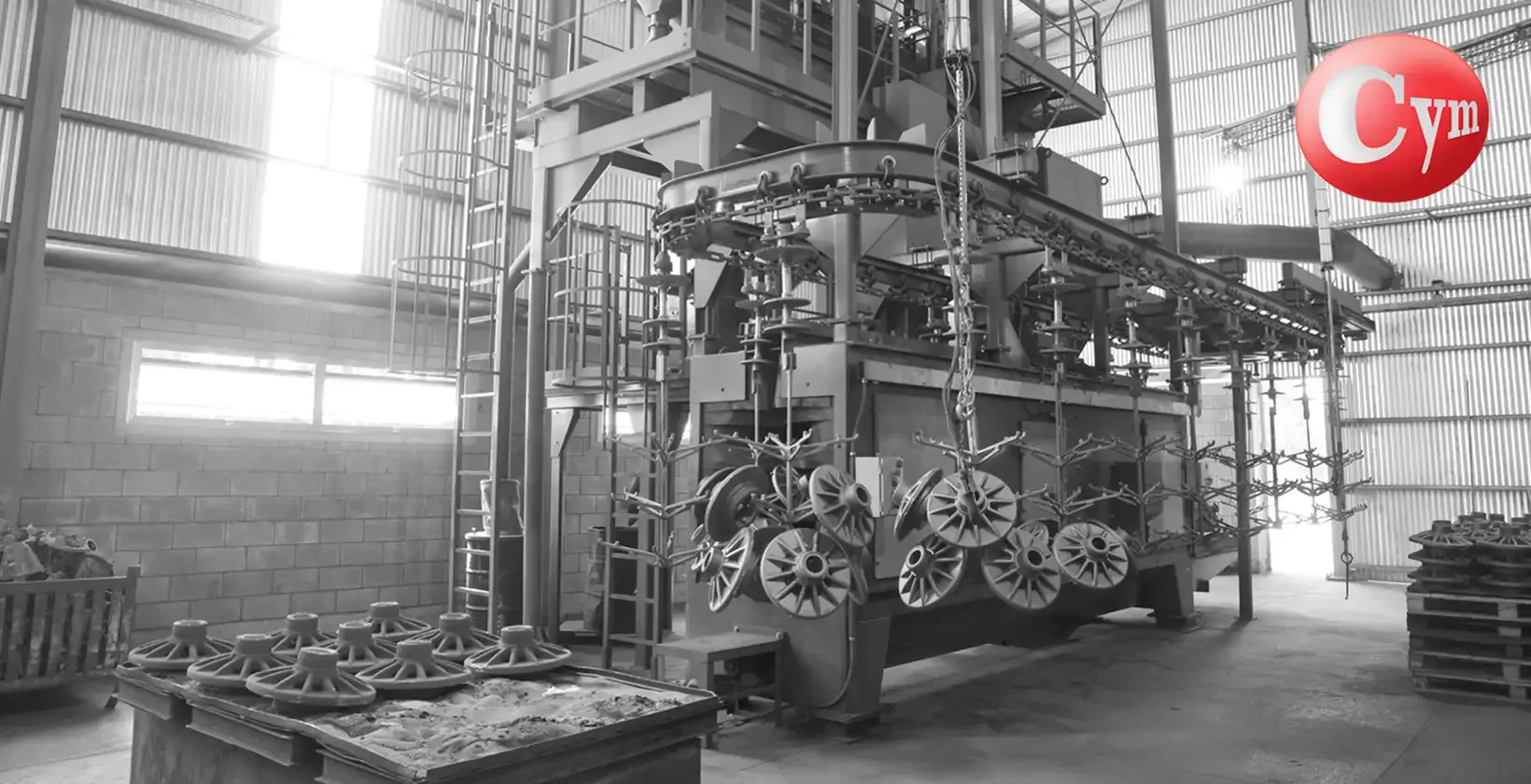 CYM TUN 8x10 continuous overhead monorail blast machine – 31" × 39" (800 × 1,000 mm) – lateral view processing grey cast iron and nodular iron castings